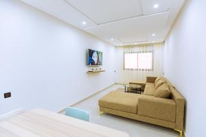 a living room with a couch and a table at EL NIDO ALHOCEIMA in Al Hoceïma +42 photos