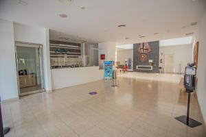 a large empty room with a lobby with a cash register at Hotel Adiafa in Barbate