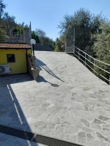 a large patio with a fence on top of it at Il Poggio Degli Olivi in Serò