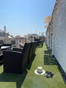 a hat sitting on the grass on a rooftop at Hotel Plaza in Seville