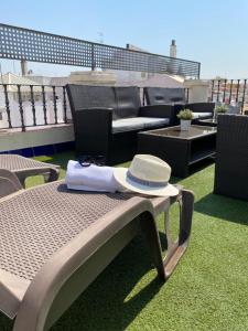 a hat and a napkin on a bench on a roof at Hotel Plaza in Seville