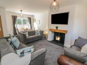 a living room with two couches and a fireplace at Woodend in Saltburn-by-the-Sea