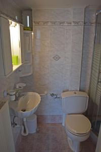 a bathroom with a toilet and a sink at Corinthian Gulf View, Apartment 2 in Egira