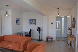 a living room with a couch and a table at Corinthian Gulf View in Egira