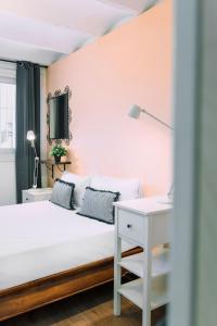 a bedroom with a white bed and a desk at Cozy place next to Park Güell in Barcelona