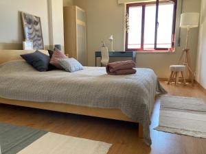 a bedroom with a large bed in a room at Oporto beach apartment in Matosinhos