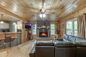 a living room with a couch and a fireplace at Listen to Chattahoochee RiverSleeps 8Near Helen in Sautee Nacoochee