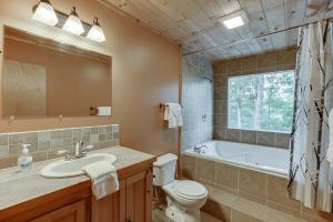 a bathroom with a tub and a toilet and a sink at Listen to Chattahoochee RiverSleeps 8Near Helen in Sautee Nacoochee +22 photos