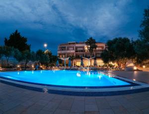 a large pool in front of a building at night at Resort Trcol in Novalja