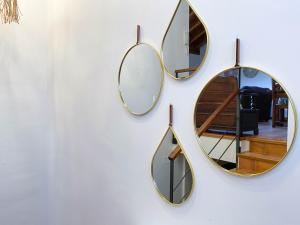 a group of mirrors hanging on a wall at Casa Jonico in Montardit