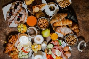 a bunch of different types of breakfast foods on a table at Urban Hotel Design in Trieste