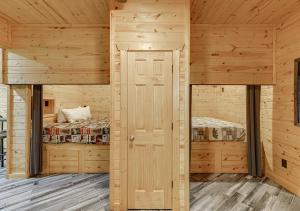 a log cabin with two bunk beds in it at Cabin Near Helen, GA w Spa Amenities in Cornelia