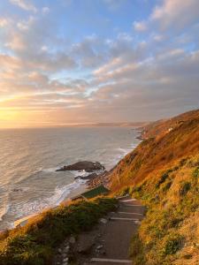 a view of the ocean from a hill at Whitsand Bay Tamar Bedroom in Downderry