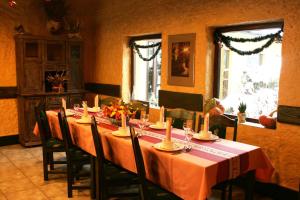 a dining room with a long table with candles on it at Hotel Kuźnia Oberża Polska in Łysomice