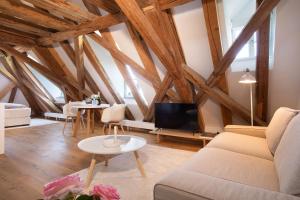 a living room with a couch and a tv at Schloss Kirchberg - Schlossnest in Immenstaad am Bodensee