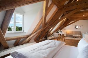 1 dormitorio en el ático con 1 cama y 1 mesa en Schloss Kirchberg - Schlossnest, en Immenstaad am Bodensee