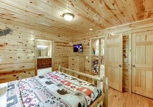 a bedroom with a bed in a wooden cabin at Private Luxury Cabin w Pool Table and Firepit in Cornelia