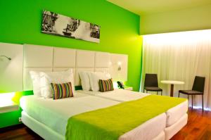 a bedroom with a large bed with green walls at Aquashow Park Hotel in Quarteira +37 photos