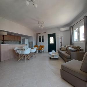 a living room with a couch and a table at Jerrys Home Agios Petros in Áyios Pétros +15 photos
