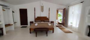 a bedroom with a bed and a chair in it at Greek "Jungle Villa", Thalassa Road, Standing alone 3bhk villa with pool in Siolim