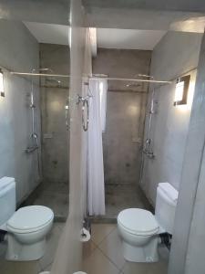 a bathroom with two toilets and a shower at Peania Domus in Paianía