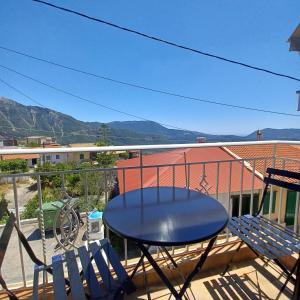 a table and chairs on a balcony with a view at Jerrys Home Agios Petros in Áyios Pétros