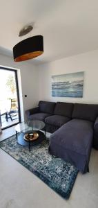 a living room with a couch and a table at Holiday house Manoka in Mali Lošinj
