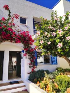 a white house with flowers on the side of it at Luxury Townhouse in Top Complex with Town and Ocean View by Be Cherish in Albufeira