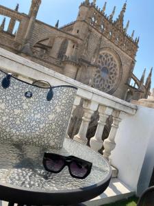 a table with a pair of sunglasses sitting on a chair at Catedral Boutique in Seville