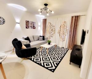 a living room with a couch and a table at Marassi Marina 2 - Salt Lake Chalet in El Alamein