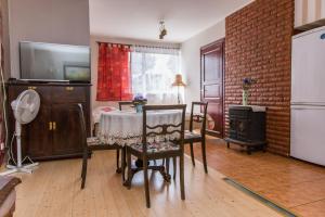 a living room with a table and chairs and a tv at Papli 2 Accommodation in Pärnu