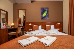 A bed or beds in a room at Patak Park Hotel - Adults Only