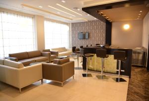 a waiting room with couches and a bar at Samarons Hotels in Tunis