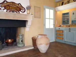 a living room with a fireplace and a large vase at La Tour D'Orgueil in Mallemort +17 photos
