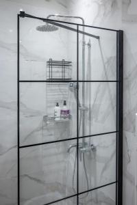 a glass shower stall in a bathroom at Deluxe Suites Irianna - in the heart of Old Town in Heraklio