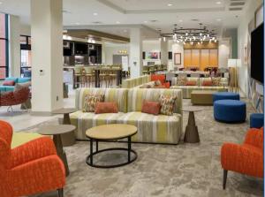 a lobby with couches and tables in a store at Hilton Garden Inn Visalia, Ca in Visalia