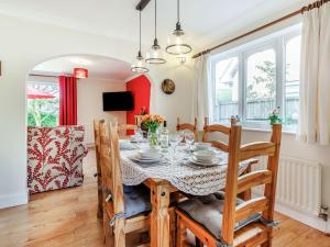 a dining room and living room with a table and chairs at The Jays in Church Stretton