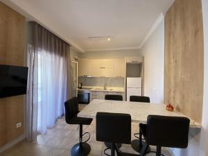 a kitchen with a table and chairs in a room at Hellen's Apartments in Ofrínion