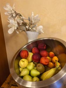 a metal bowl of fruit on a table at Hotel Binelli in Pinzolo