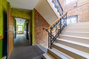 a staircase in a building with a brick wall at Villa Fortuna in Duszniki Zdrój