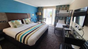 a hotel room with a bed and a bunk bed at The Plough Inn in Llandeilo