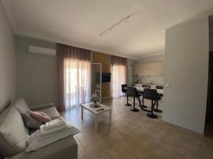 a living room with a couch and a table at Hellen's Apartments in Ofrínion +9 photos