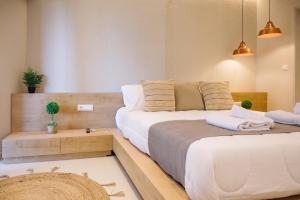 two beds in a small room with two towels at Eleftherias Suites - Near Beach Apartments in Marathi