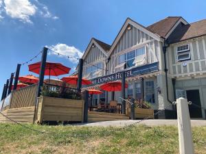 a building with red umbrellas in front of it at Downs Hotel in Stanmer