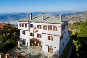 an aerial view of a white house with an arch at Erofili Hotel & Suites in Portaria