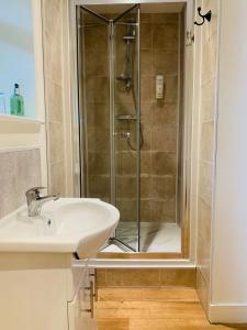 a bathroom with a shower and a sink at The Yew tree at Longhope in Longhope
