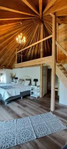 a large room with two beds and a wooden ceiling at Herberg de Lingehoeve in Oosterwijk