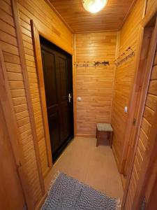 a hallway with a door and a bench in a room at KurBrauksim Goldingen Apartments in Kuldīga