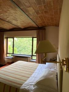 Кровать или кровати в номере Hotel Gattapone