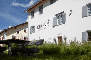 a white building with the word improve written on it at Krone Säumerei am Inn in La Punt-Chamues-ch